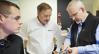 Men working together on parts