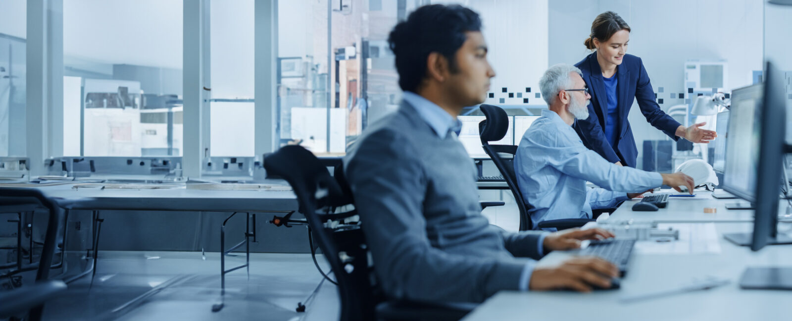 A team of engineers in from of computer workstations