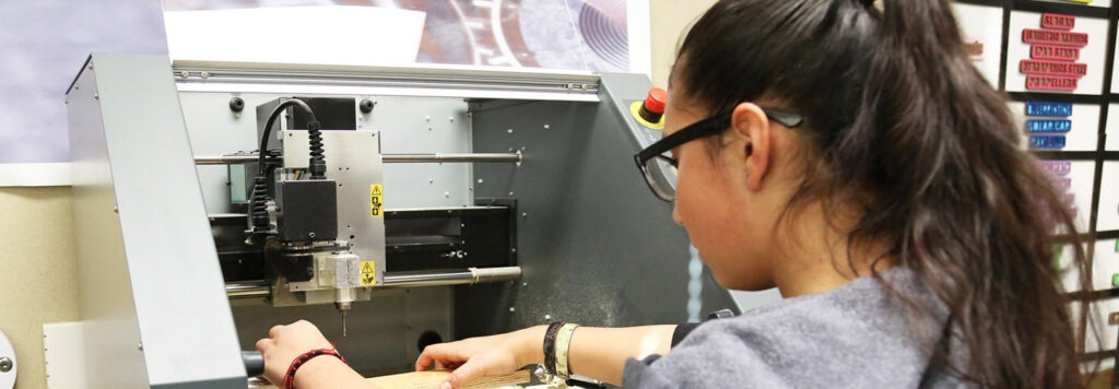 Alexa Aquino from Leland Elementary using machinery in a STEM class