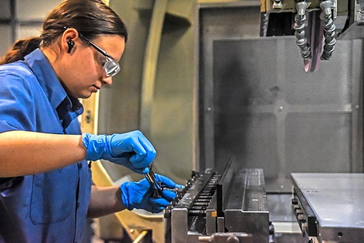 Female engineer using manufacturing parts