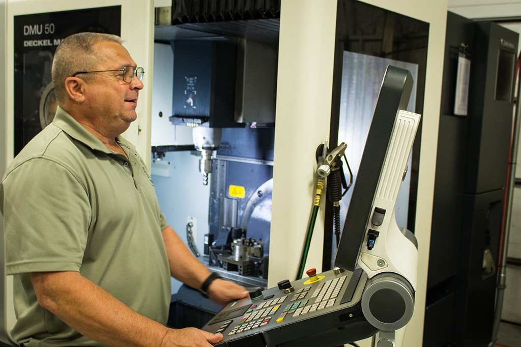 Bobby Bassett using a large standing monitor and keyboard