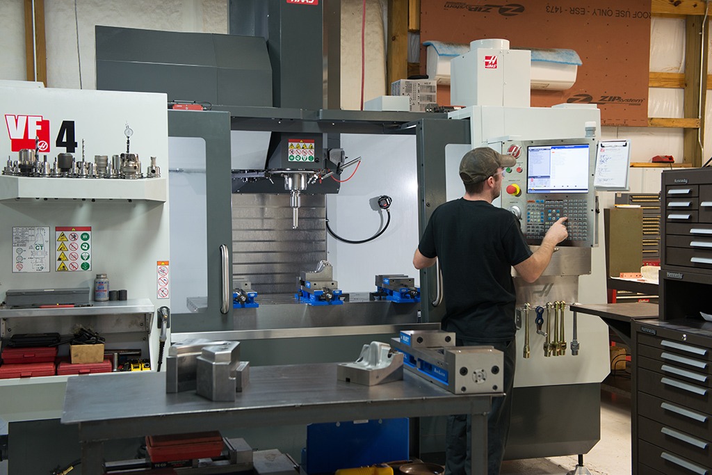 A Triple C employee using part on a Haas