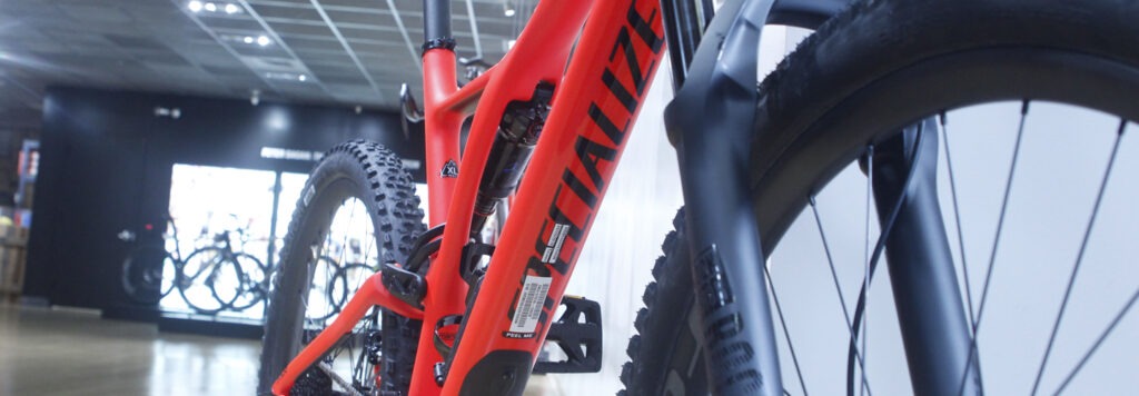 Close up of the body and tires of a red specialized bike