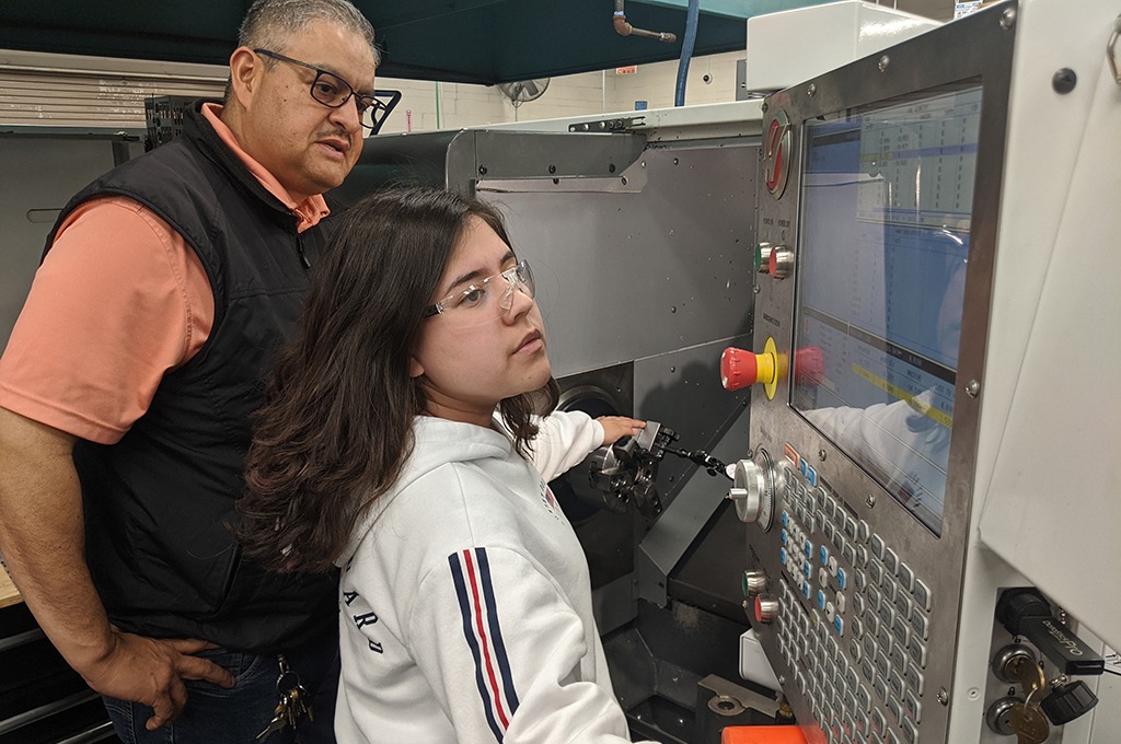 Teacher and student at machine control