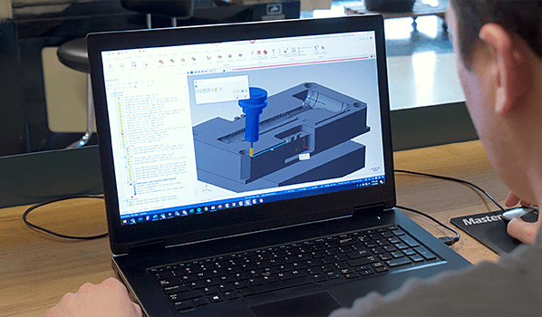 Man using mastercam  software on a laptop