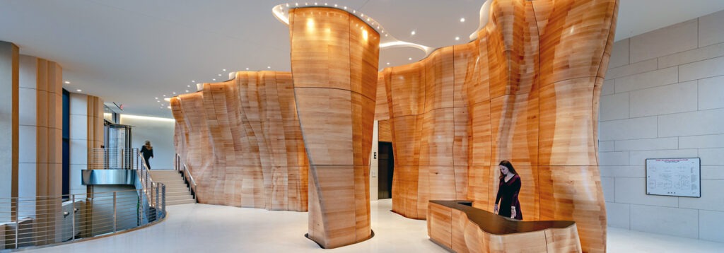 Modern light wooden floor to ceiling pillars in a lobby
