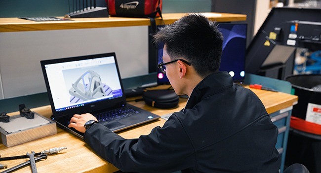 man sitting at desk with laptop