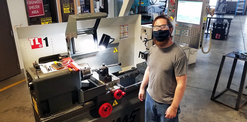 Texas State Technical College student Brian Gannon works on a part on a CNC lathe.