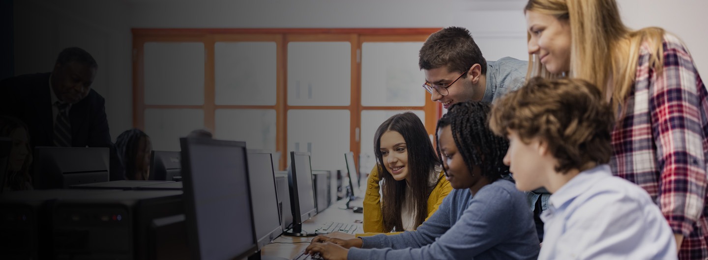 teacher and students looking at a computer screen