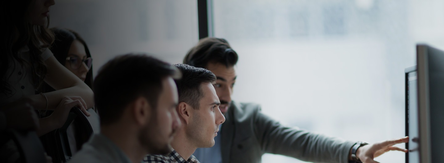 group of people looking at computer screen