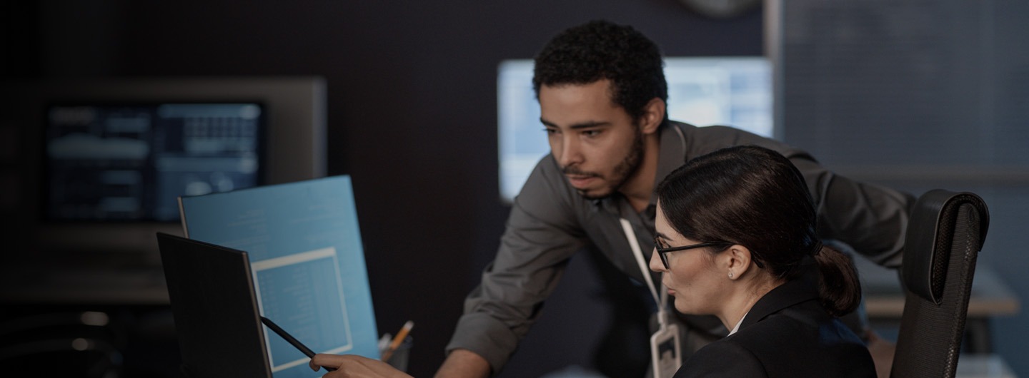 Two people looking at computer screen