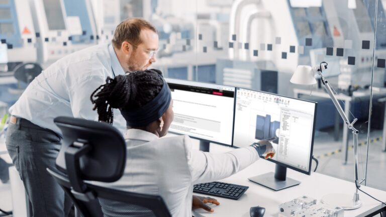 Photo of a man and a woman looking at a computer screen