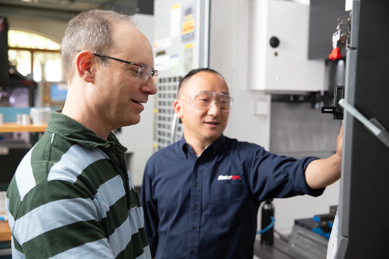 Men in front of a CNC machine