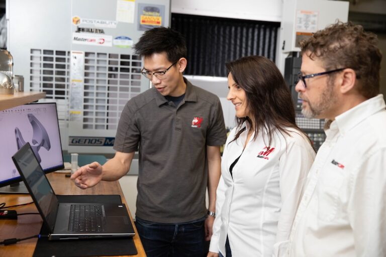 Team reviewing work on a computer
