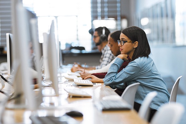 Support agents in front of computer screens.