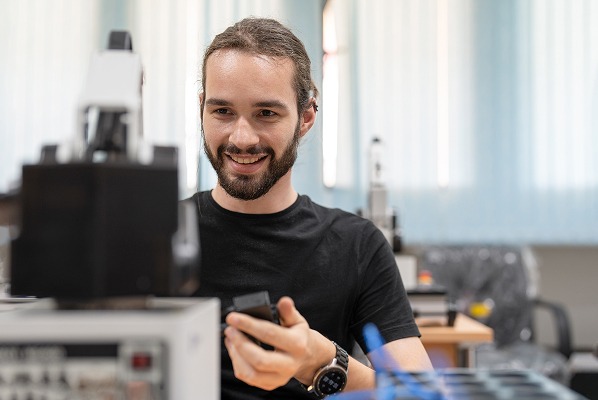 Man in a lab smiling